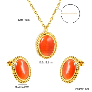 Detail view of oval orange cat-eye jewelry set with gold lace edges and size dimensions