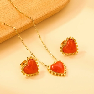 Vintage stainless steel jewelry set with orange cat-eye heart pendant and earrings