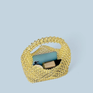 Detail showing internal capacity of handmade yellow beaded tote bag with daily essentials