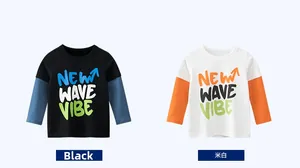 Detail view of boys' layered long sleeve shirts in black and off-white with graffiti print