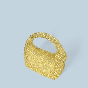 Macro shot of handcrafted bright yellow acrylic beaded tote bag with clear texture