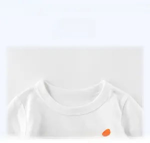 Close-up of a white cotton boys' T-shirt neckline with clean knitted fabric details