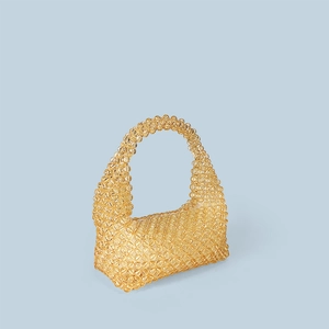 Detail of handcrafted amber acrylic beaded tote bag with intricate woven texture