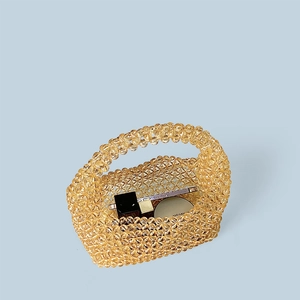 Detailed close-up of amber translucent handmade beaded tote showing cosmetic storage space