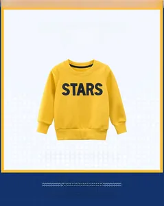 Detail of a bright yellow kids sweatshirt with black STARS print and soft cotton texture