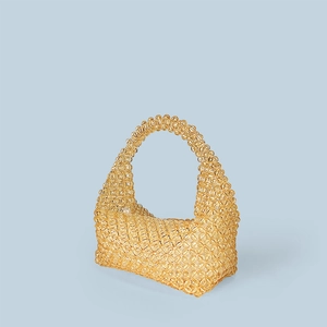 Detail showing amber orange hand-beaded acrylic tote bag with faceted crystal texture