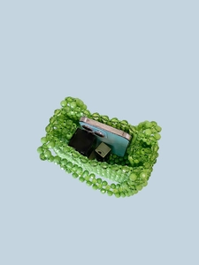 Handmade green beaded handbag with floral patterns showing interior storage capacity