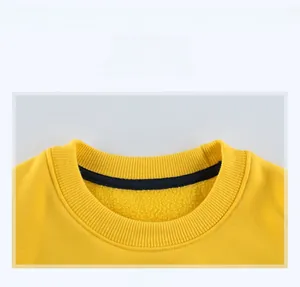 Macro shot of yellow crewneck sweatshirt collar with black tape and fleece lining