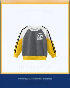 Detail of kids grey sweatshirt with yellow colorblock sleeves and black side stripes