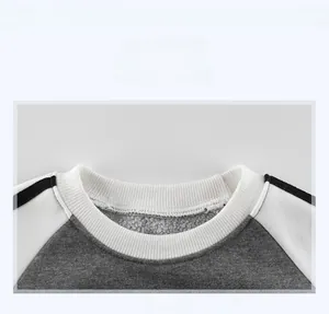 Detail shot of a kids' color-block sweatshirt with ribbed neckline and fleece lining