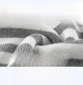 Close-up of soft breathable grey and white striped knit fabric for kids sweaters