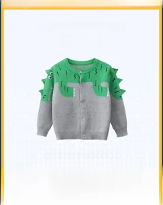 Detail of boys knit dinosaur cardigan featuring 3D green spikes and button closure