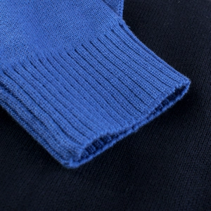 Close-up of blue ribbed cuffs on children's knitted sweater with premium fabric texture