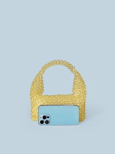 Chic yellow handmade beaded tote bag with stylish rounded handle shown against blue backdrop