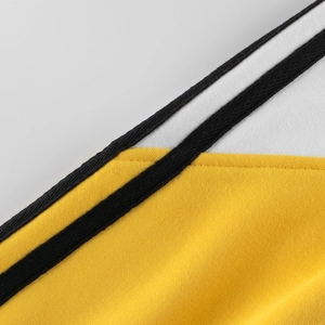Kids sports sweatshirt featuring bright yellow and white color-blocking with black stripes