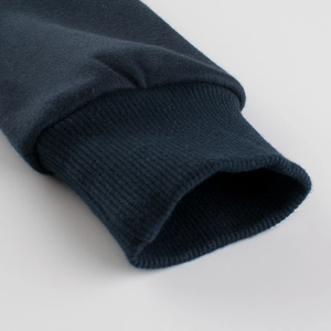 Close-up of navy blue ribbed cuffs on kids long-sleeved fleece sweatshirt for autumn winter