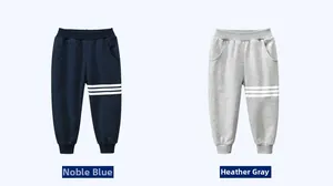 Detail of kids knit joggers featuring three white stripes and elastic ribbed cuffs
