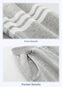 Detail of gray cotton joggers showing three white side stripes and elastic waist pocket