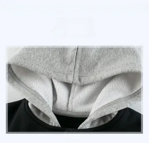 Detail view of boys fleece lined hoodie featuring gray contrast lining and neat neckline