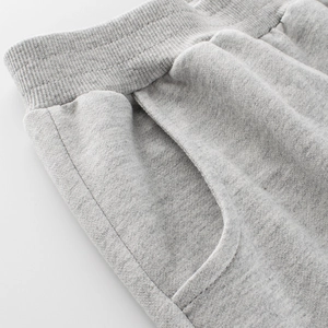 Kids light grey cotton joggers featuring elastic waistband and side pocket details