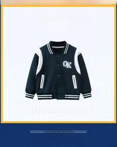 Detail of navy boy's baseball jacket with white sleeves and 'OK' embroidered patch
