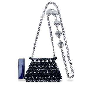 Detail of handmade black beaded mini bag with silver chain and vintage coin accents