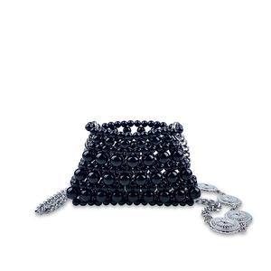 Close-up of black beaded mini handbag with silver chain and metal charm detail