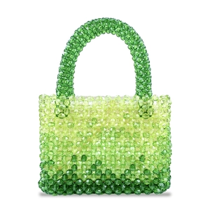 Detail of handmade beaded handbag with gradient green acrylic beads and woven texture