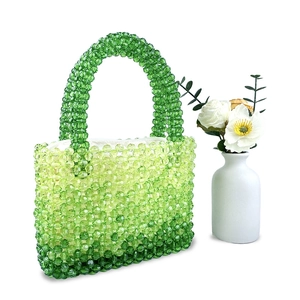 Detailed view of handmade gradient green beaded handbag with transparent acrylic beads