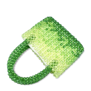 Detail of green gradient handmade beaded bag showing clear acrylic beads and white zipper
