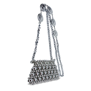 Detail of silver beaded mini bag featuring sunburst metal medallions on a chain strap