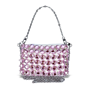 Detail of pink crystal beaded handbag with silver metal chains and luxury rhinestone texture