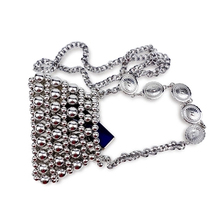 Detail of silver beaded handmade mini bag with sun-pattern embossed metal chain strap