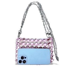 Miniature pink crystal beaded bag shown with a smartphone to display size and capacity