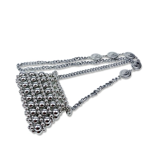 Detailed view of handmade silver mirror metal bead bag with pearl chain and relief charms