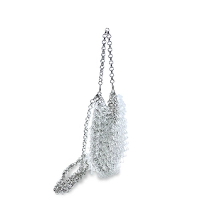 Close-up of silver metal chain evening bag with transparent acrylic scale detailing