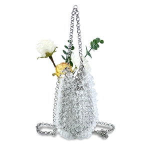 Detail of beaded evening bag with silver metal chain strap and acrylic water drop beads