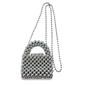 Dettaglio borsa a mano in perline d'argento con sfere metalliche e tracolla a catena