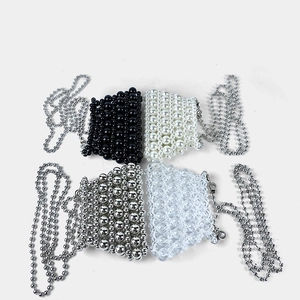 Detail view of four mini handmade beaded bags in black, white, silver and clear styles