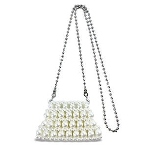 Detailed view of handmade woven pearl mini bag with elegant silver ball chain strap