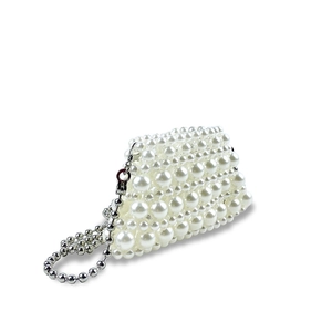 Detailed view of woven pearl mini bag featuring a silver metal ball chain strap