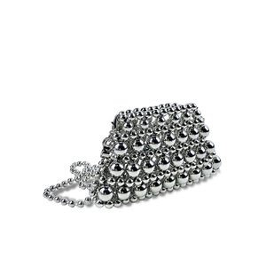 Detailed view of silver metallic beaded mini bag with elegant pearl-style chain strap