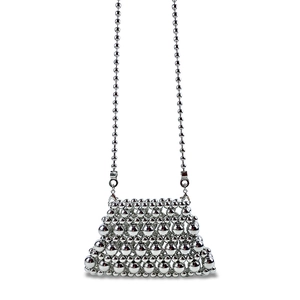 Detail of silver beaded mini crossbody bag featuring metallic pearls and chain strap