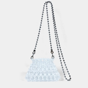 Detail of a mini beaded crossbody bag with transparent spheres and a sleek metal chain