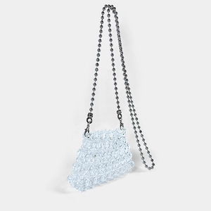 Detail of handcrafted transparent beaded mini bag with elegant silver ball chain strap