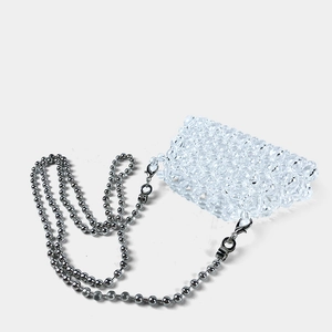 Detailed macro of a transparent beaded mini bag with elegant silver ball chain strap