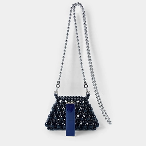 Detailed view of mini black beaded bag with silver ball chain and lipstick for scale