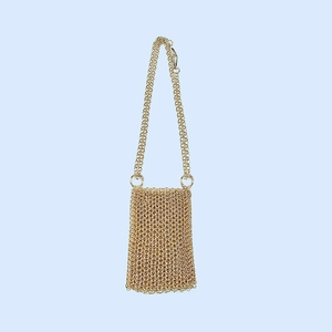 Close-up of golden handmade chainmail weave texture on a mini metallic crossbody bag