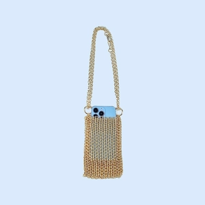 Close-up of gold chainmail crossbody phone bag with interlocking metal ring mesh texture