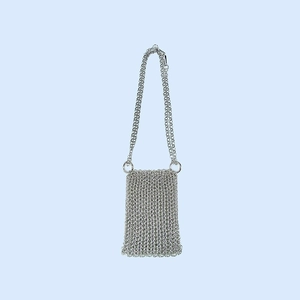 Detailed view of silver handmade woven metal chainmail phone bag with crossbody strap